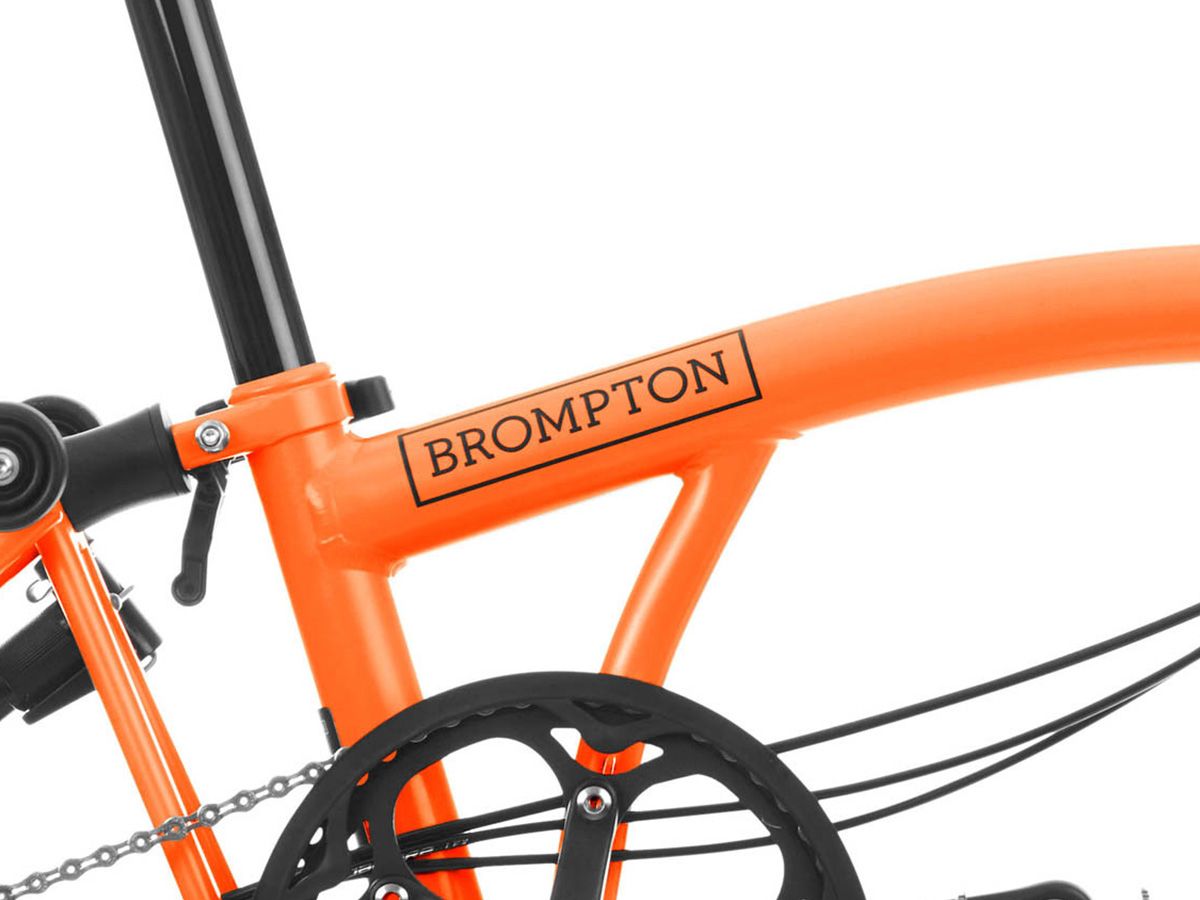 Brompton C Line Explore Sunset Orange - 6 speed with Mid handlebar, with Front Carrier Block and roller frame